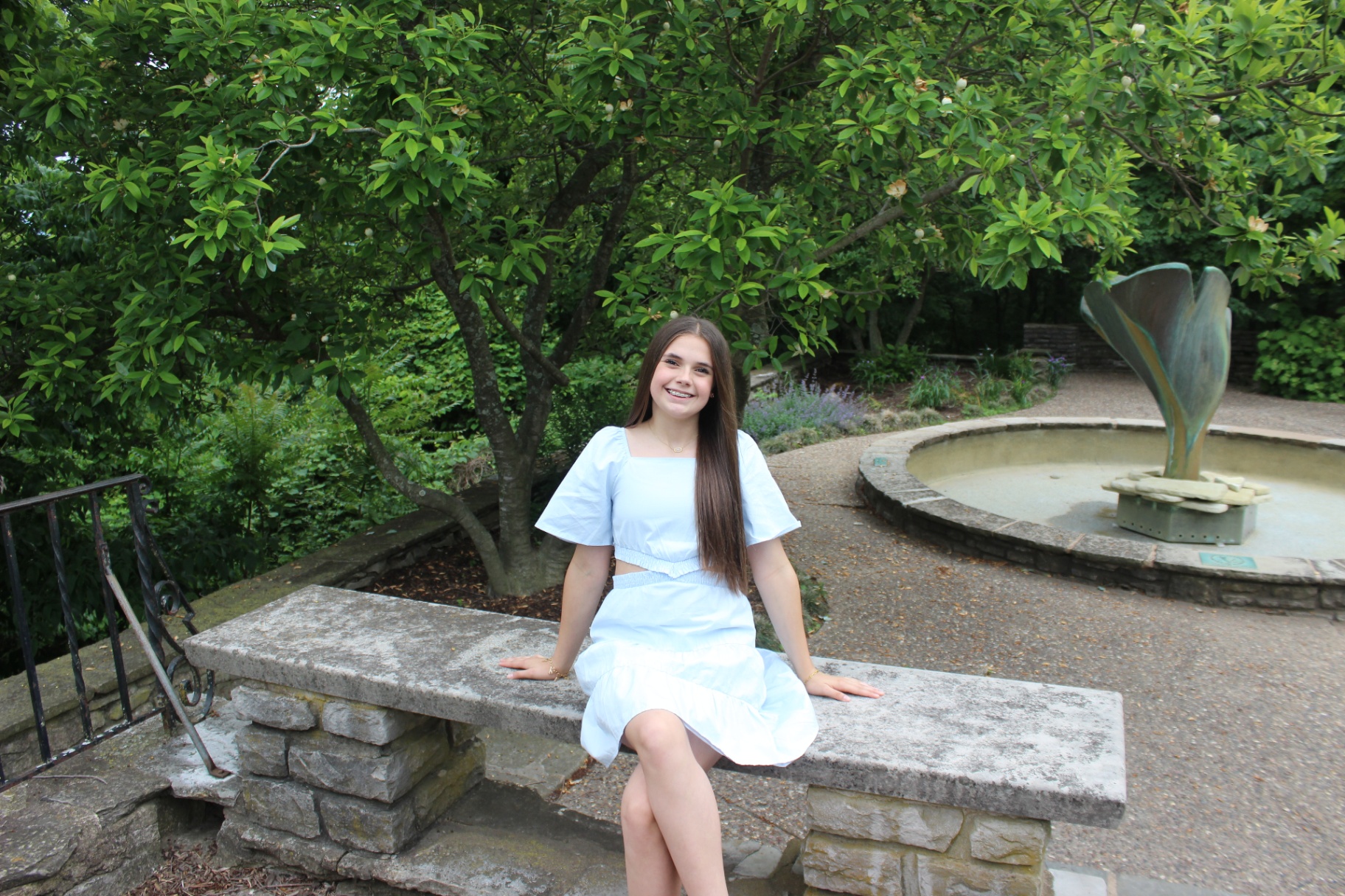 Addyson sitting in a garden